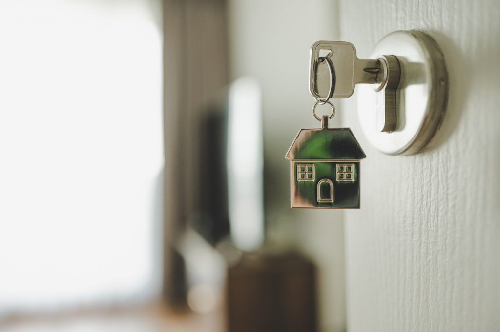 Home equity: door handle with a key and a keychain shaped house