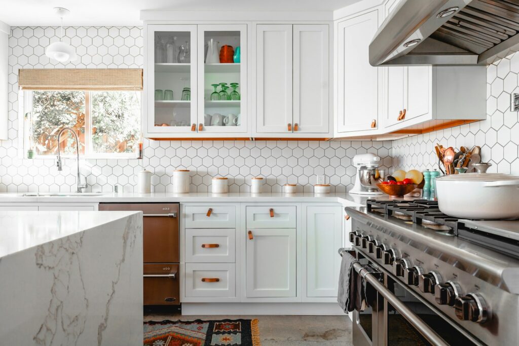 Staged kitchen with clear countertops, white cabinets and a few simple accessories