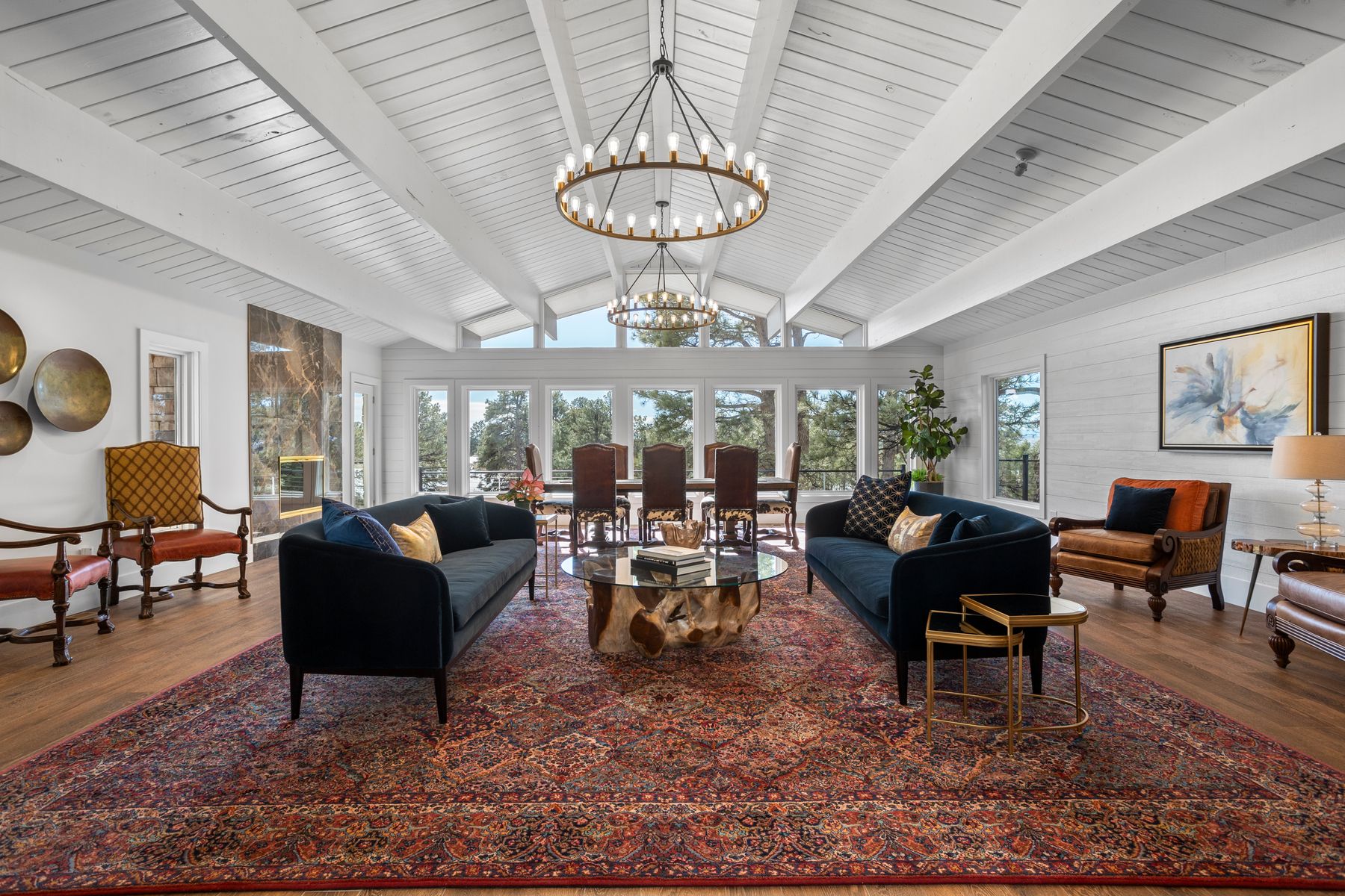 Luxury great room at 8740 Hilltop Road with vaulted ceilings, chandeliers, and panoramic views
