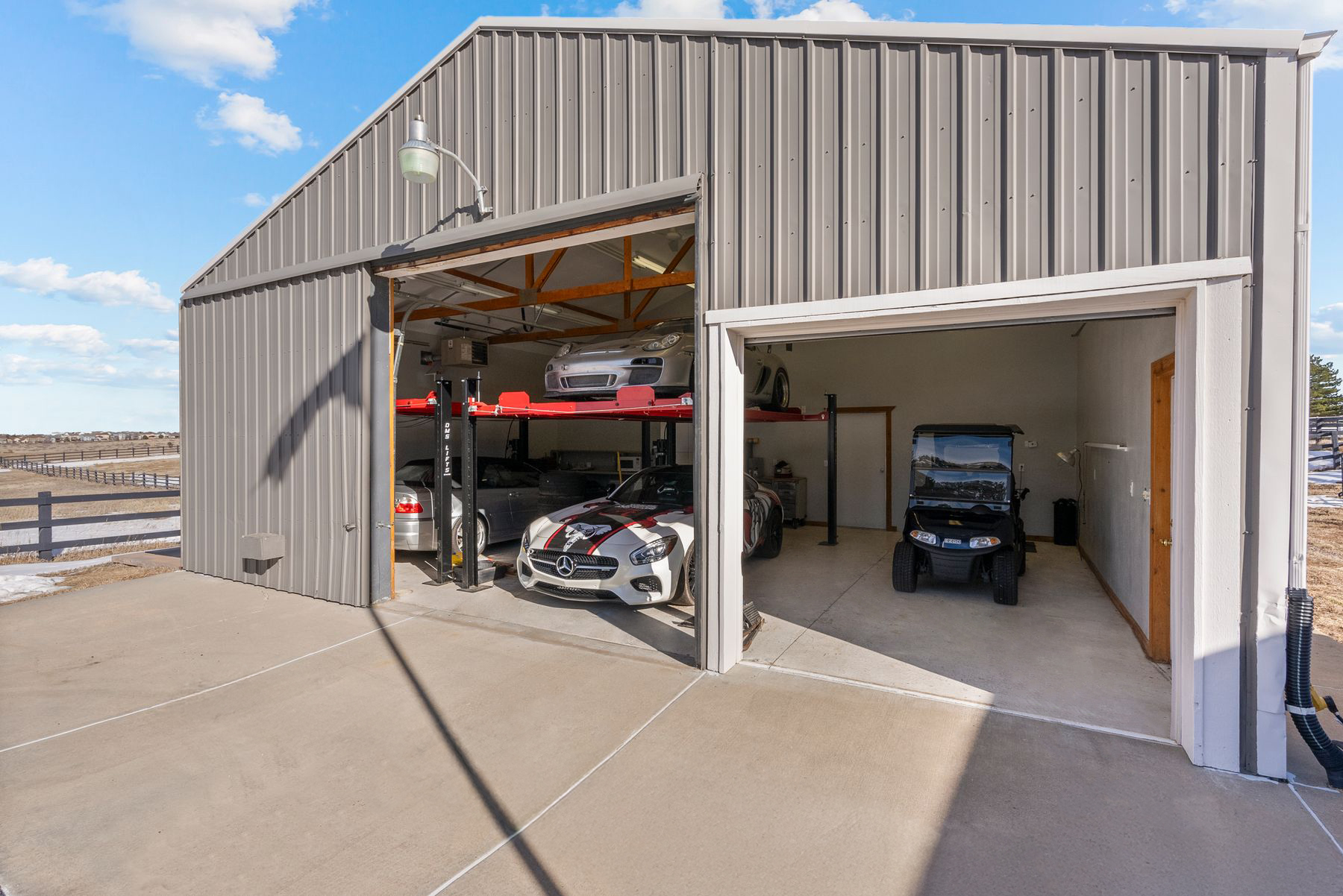 Heated shop at 8740 Hilltop Road with multiple car lifts, vehicle storage, and workshop space