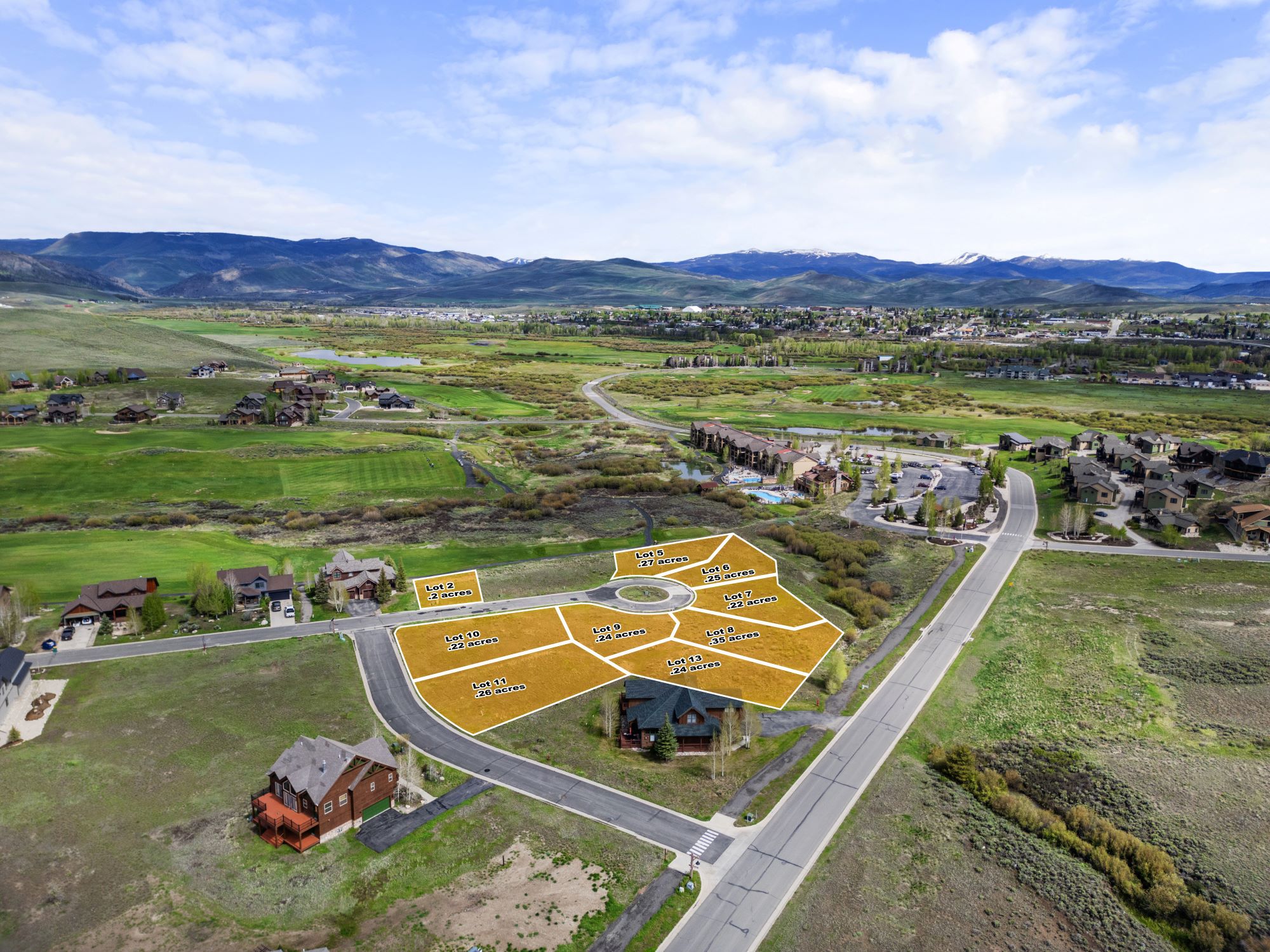 Mountain-view development lot in Granby, Colorado featuring treed surroundings and open land adjacent to a golf course and mountain terrain.