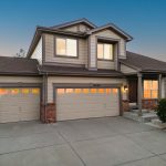 Sold home at 10606 Kalispell St, Commerce City, Colorado — two-story with three-car garage, brick accents, and landscaped yard