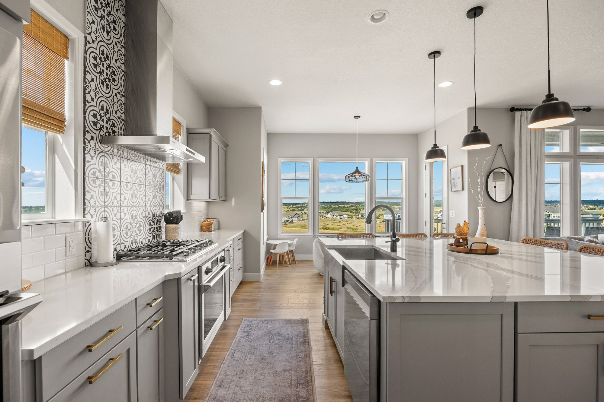 Kitchen interior looking toward breakfast nook and large view windows overlooking Franktown’s open landscape.